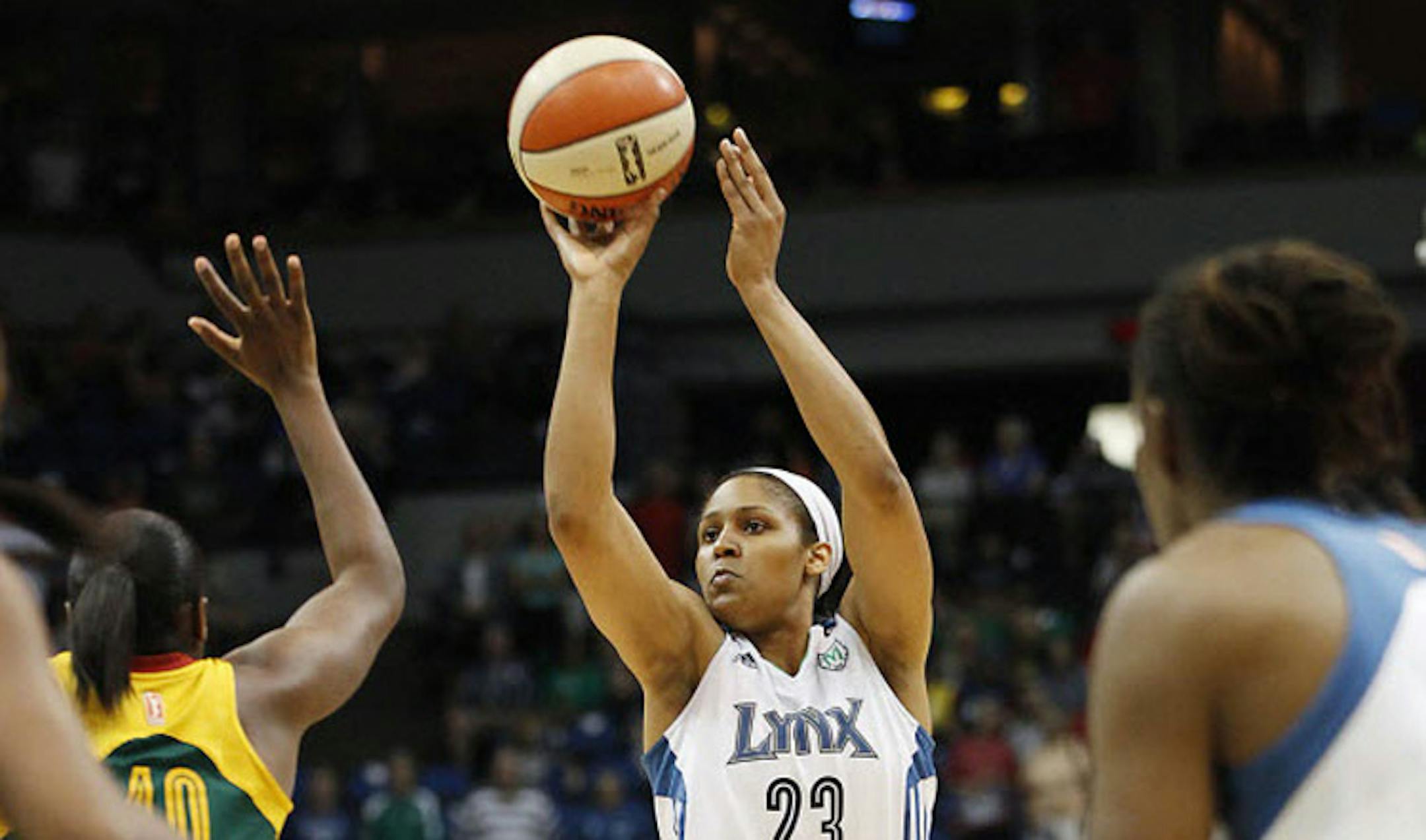 Minnesota Lynx forward Maya Moore (23) takes a shot against Seattle Storm guard Shekinna Stricklen (40) in the first half of a WNBA basketball game Saturday in Minneapolis.