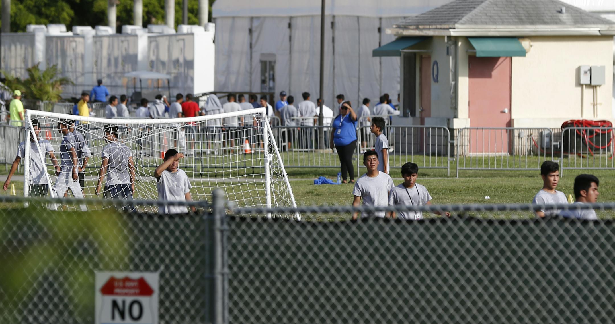 Immigrant children play outside a former Job Corps site that now houses them, Monday, June 18, 2018, in Homestead, Fla. It is not known if the children crossed the border as unaccompanied minors or were separated from family members. Wrenching scenes of migrant children being separated from their parents at the southern border are roiling campaigns ahead of midterm elections, emboldening Democrats on the often-fraught issue of immigration (AP Photo/Wilfredo Lee)