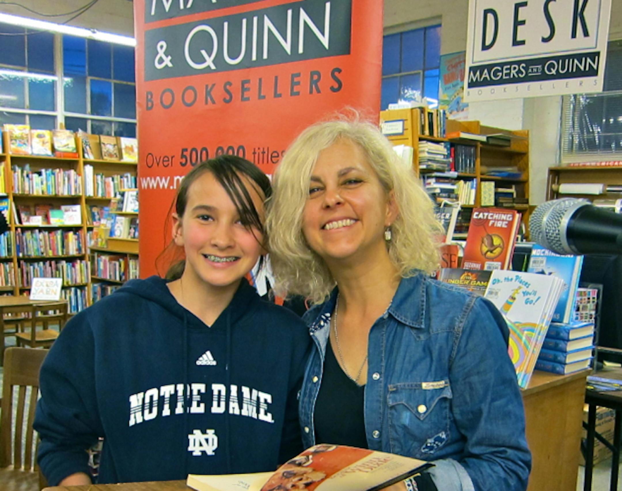 Kate DiCamillo meets a reader (and a fan) named Anna Wilkens at the World Book Night 2012 event at Magers and Quinn.