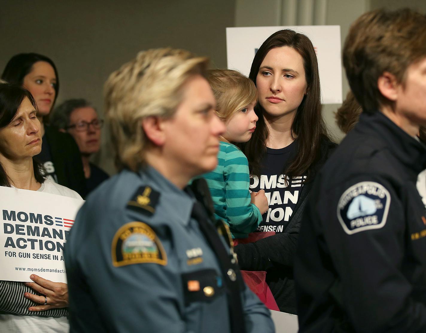 Erin Preese, right, a school teacher, held her daughter Scarlett Preese, 3, as she joined other volunteers with the Minnesota chapter of Moms Demand Action for Gun Sense in America, members of the Everytown Survivor Network, local law enforcement and DFL lawmakers joined to support Senator Ron Latz and Representative Dan Schoen's introduction of a new gun safety bill during a press conference at the Minnesota State Office Building, Thursday, March 10, 2016 in St. Paul, MN. ] (ELIZABETH FLORES/ST