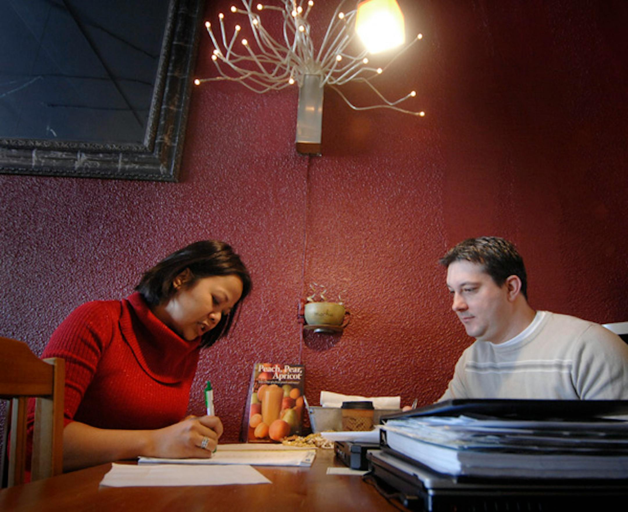 Channa Tastsides and her fiancé and business partner, Troy Lerch, went over a shopping list for their upcoming Valentine's Day party at the Firefly Coffee Bistro in south Minneapolis.