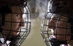 (Left) University of Minnesota Duluth defensemen Nick Wolff and Scott Perunovich posed for a portrait on the ice of Amsoil Arena on Tuesday. ]
ALEX KO