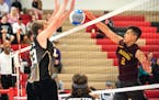 Andover's Derek Owens blocks a kill attempt by St. Paul Harding's Newjai Chang during Sunday's boys' volleyball state championshp match. Andover won 2