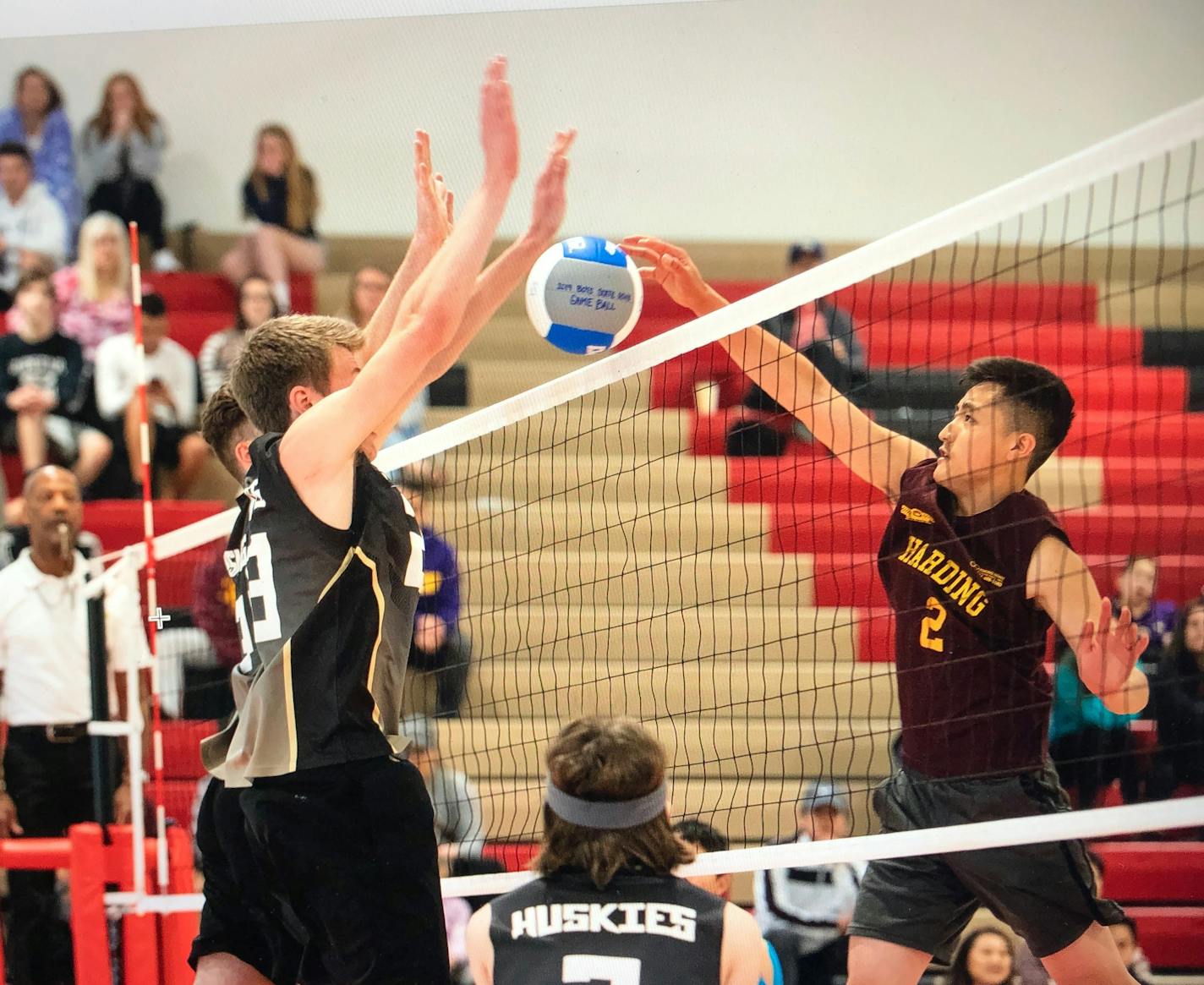 Andover's Derek Owens blocks a kill attempt by St. Paul Harding's Newjai Chang during Sunday's boys' volleyball state championshp match. Andover won 25-13, 19-25, 25-7, 25-23