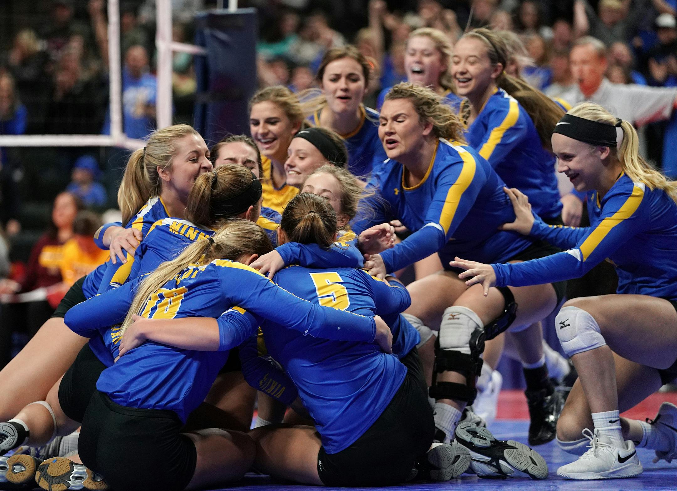Minneota players were mobbed by their team on the court celebrating their victory over Medford High School at the end of the third set. ] ANTHONY SOUFFLE ï anthony.souffle@startribune.com Minneota High School played Medford High School in a Class 1A state volleyball championship game Saturday, Nov. 10. 2018 at the Xcel Energy Center in St. Paul, Minn.