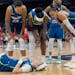 Minnesota Lynx players look after Minnesota Lynx guard Rachel Banham (15) after she fell during the fourth quarter at the Target Center, in Minneapoli