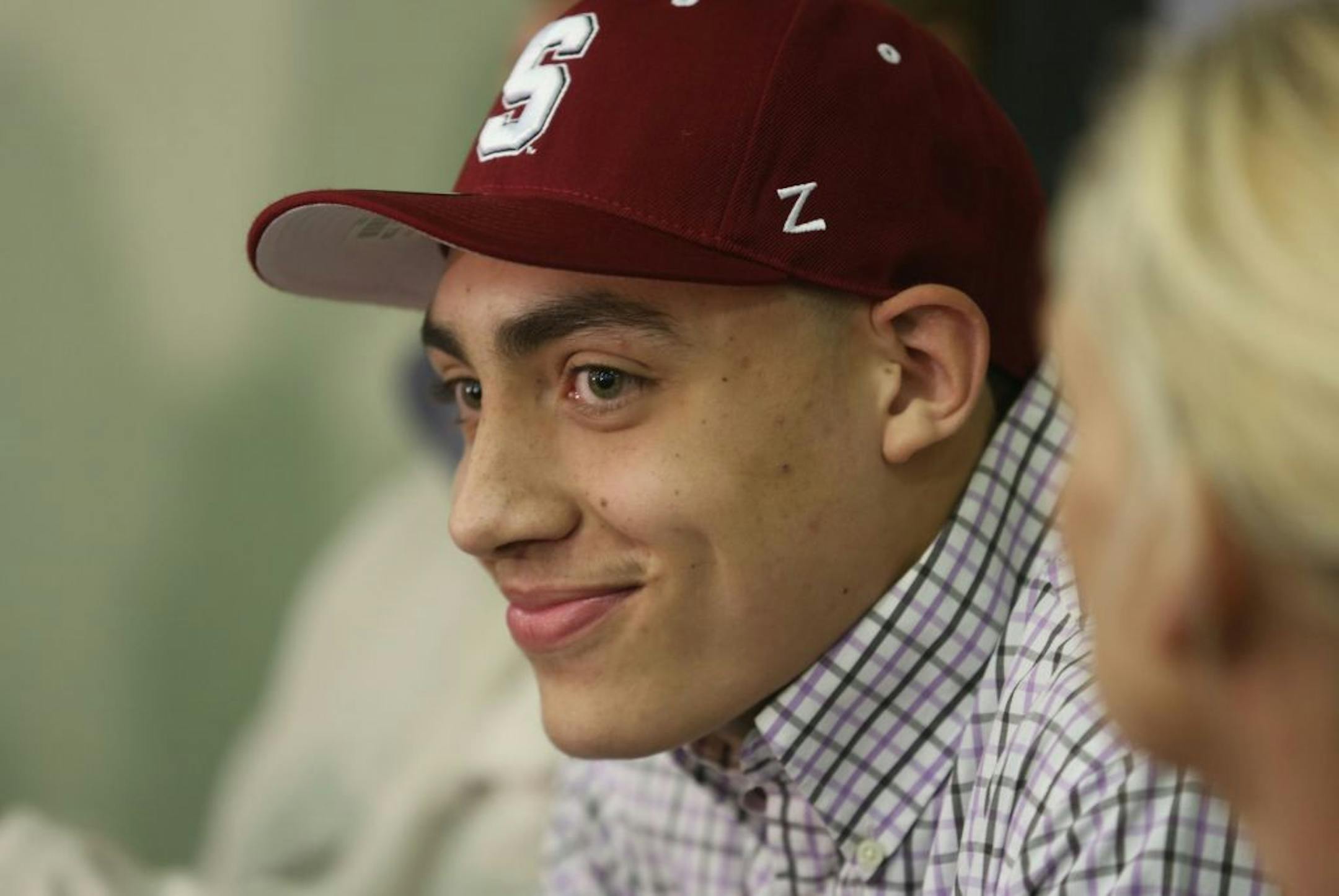 Reid Travis smiled at friends after announcing that he will attend Stanford University during a press conference at DeLaSalle.