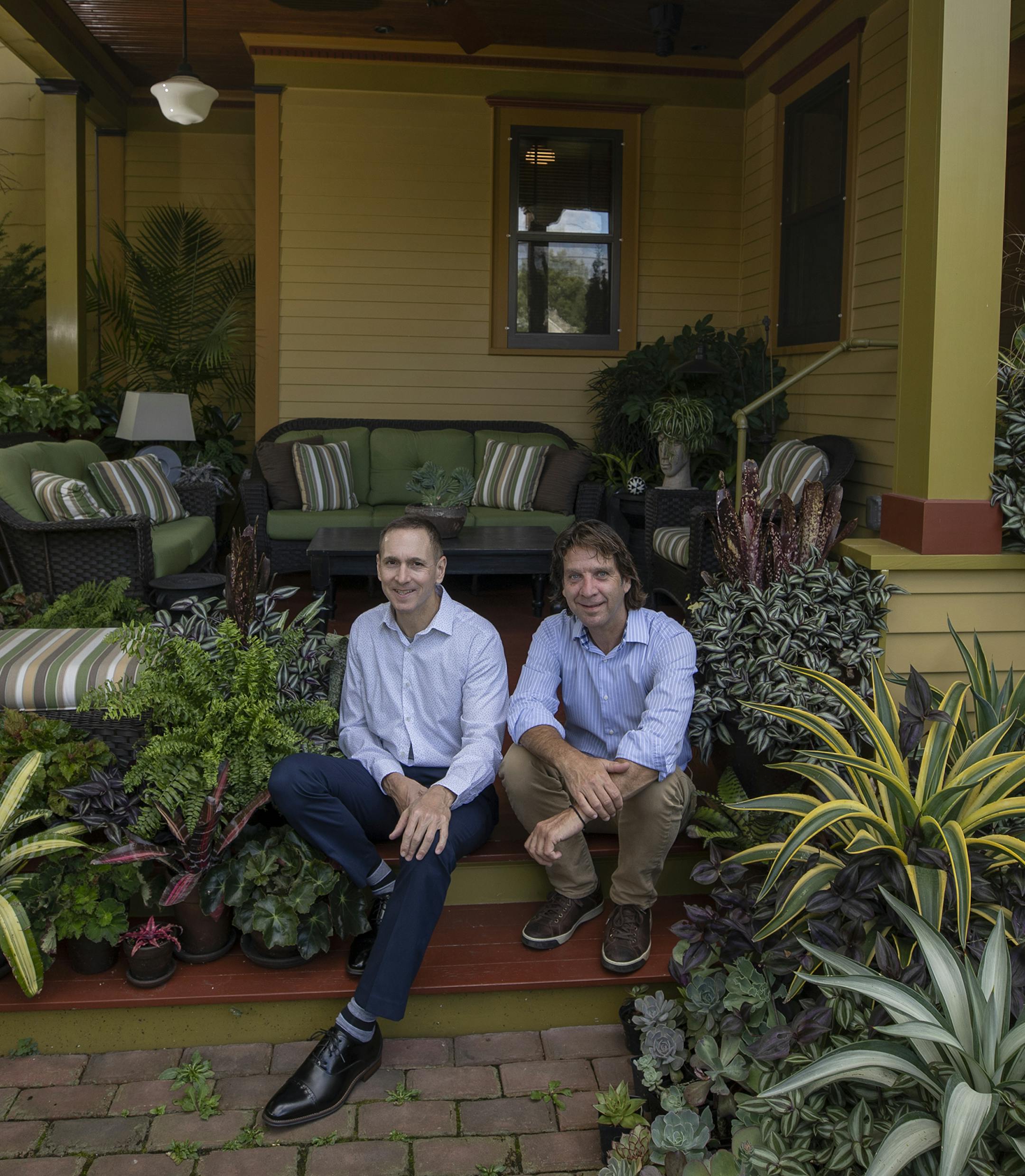 John Evans, left, and Frank Fitzgerald on their recently added porch, which complements their 1909 house.