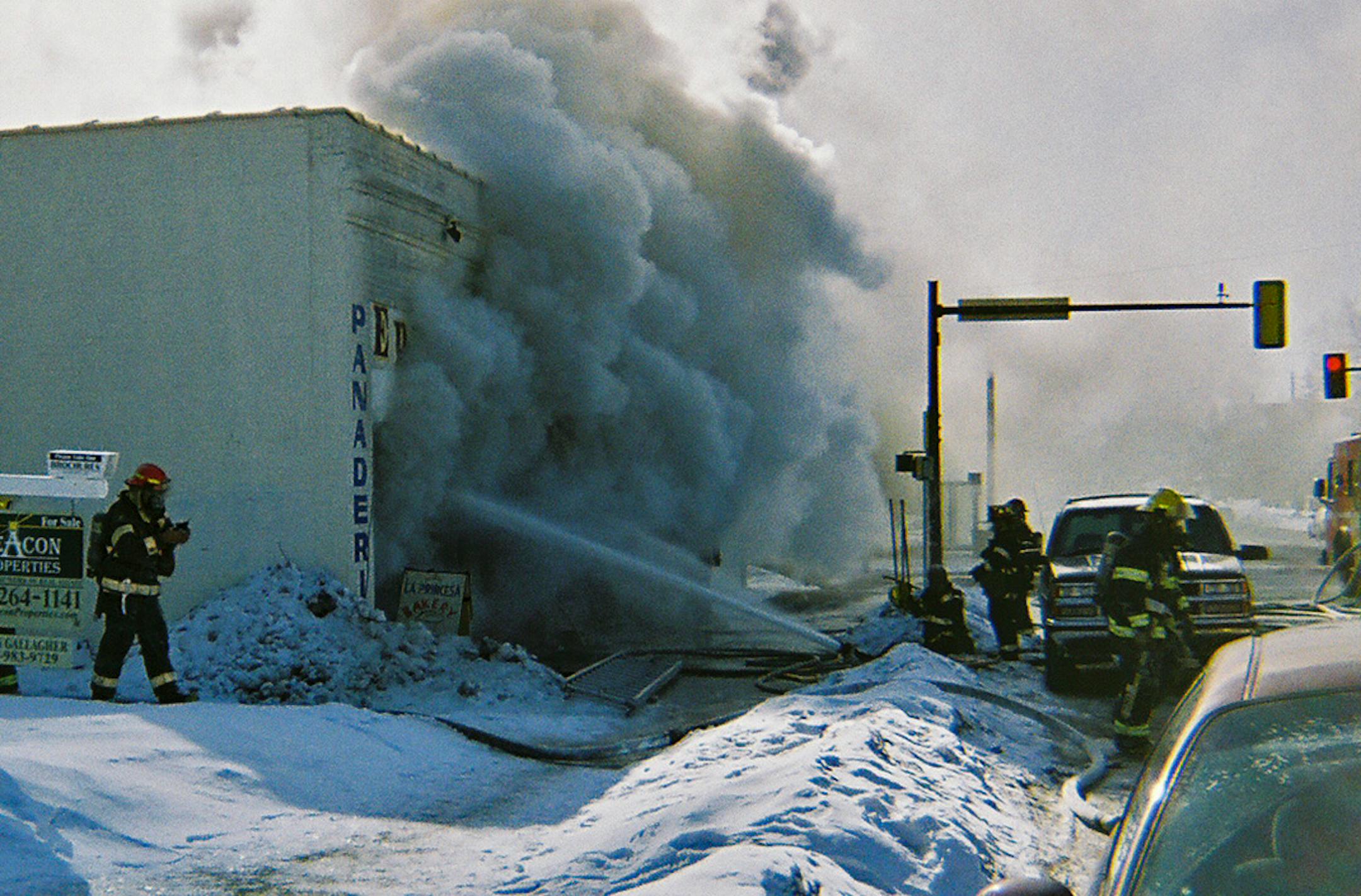 Special to the Star Tribune/Eric Silverman - Firefighters fight a building fire on 34th & Nicollet that housed several businesses including Jojo's Urban Clothing