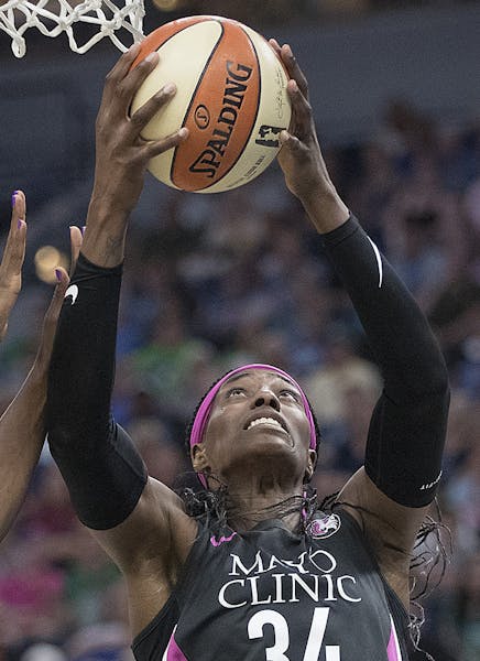 Minnesota Lynx center Sylvia Fowles took it to the net above Seattle Storm's forward Crystal Langhorne during the fourth period as the Minnesota Lynx 