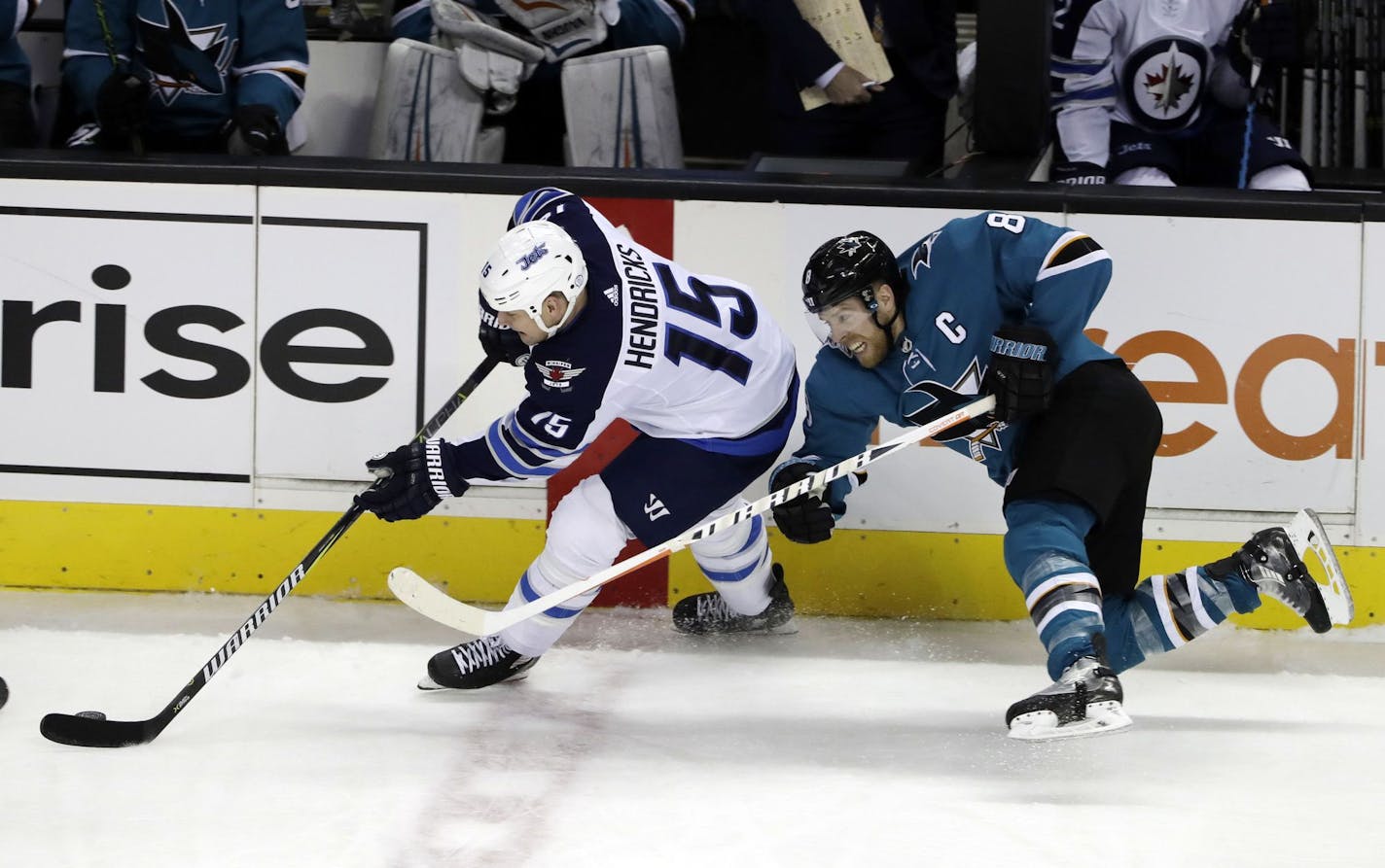 Winnipeg Jets' Matt Hendricks (15) works against San Jose Sharks' Joe Pavelski during the third period of an NHL hockey game Tuesday, Jan. 23, 2018, in San Jose, Calif. (AP Photo/Marcio Jose Sanchez) ORG XMIT: SJA215