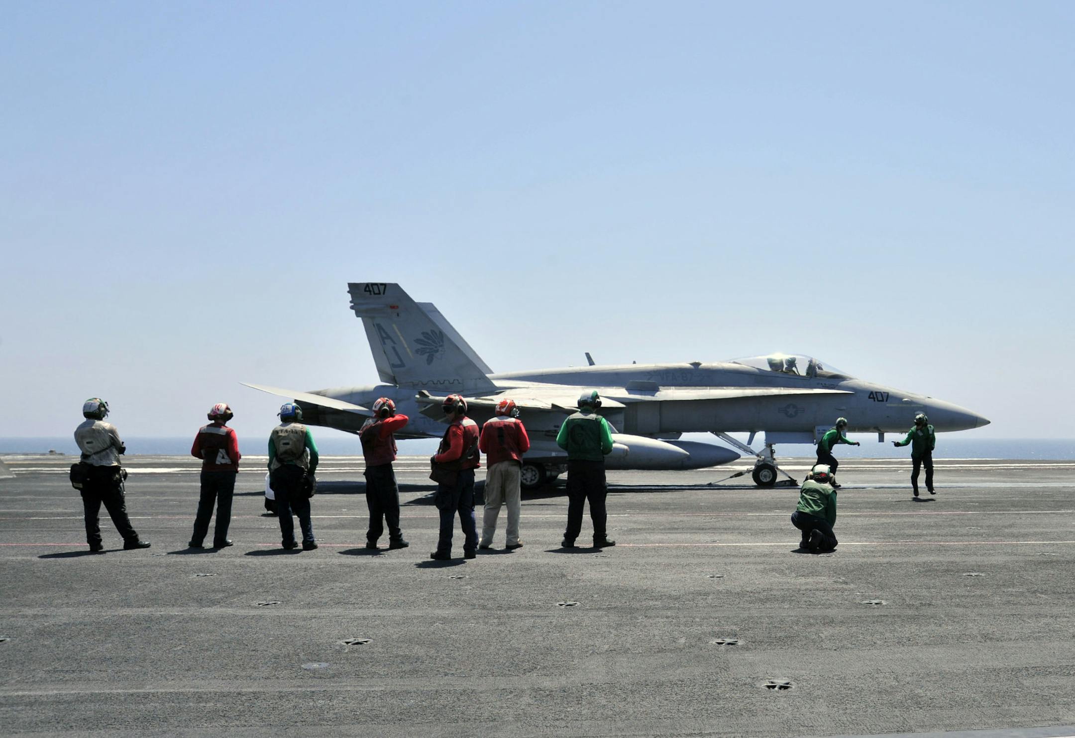 This image released by the U.S. Navy shows sailors make final inspections on an F/A-18C Hornet assigned to the Golden Warriors of Strike Fighter Squadron (VFA) 87 aboard the aircraft carrier USS George H.W. Bush (CVN 77) on Thursday, Aug. 7, 2014 in the Persian Gulf. George H.W. Bush is supporting maritime security operations and theater security cooperation efforts in the U.S. 5th Fleet area of responsibility. (AP Photo/U.S. Navy, Margaret Keith)
