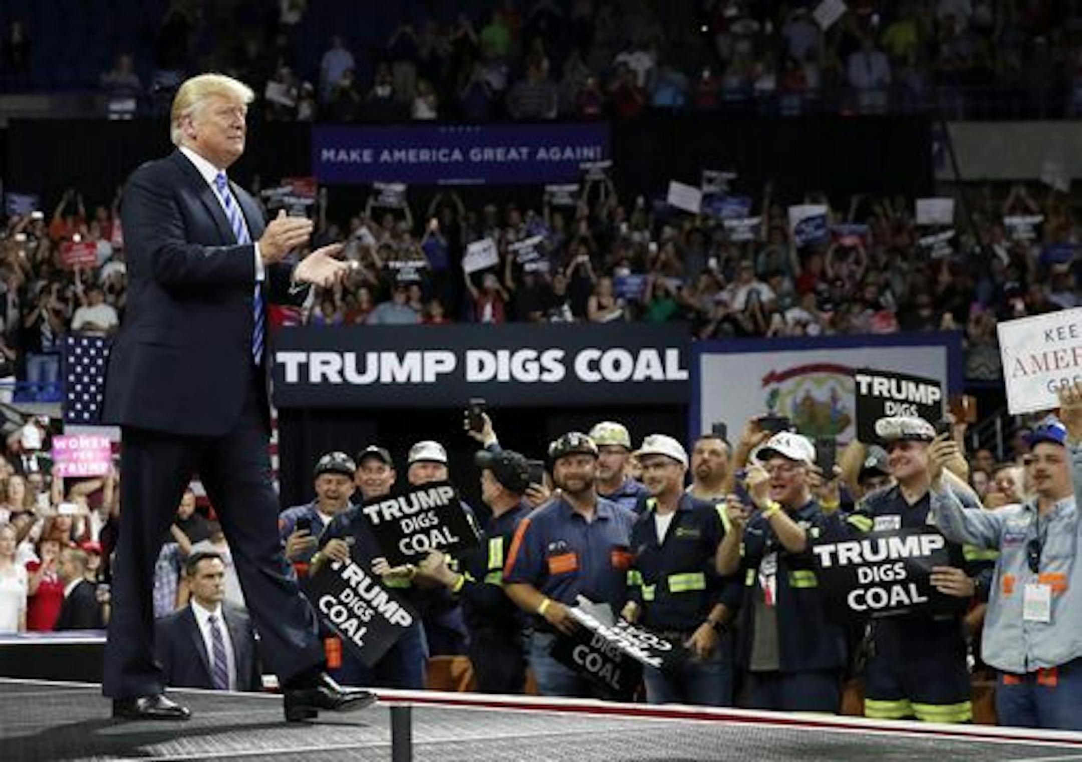 President Donald Trump was a strong advocate for the coal industry when he was running for president, as signs emphasized at a rally Aug. 21, 2018, in Charleston, W.Va.
