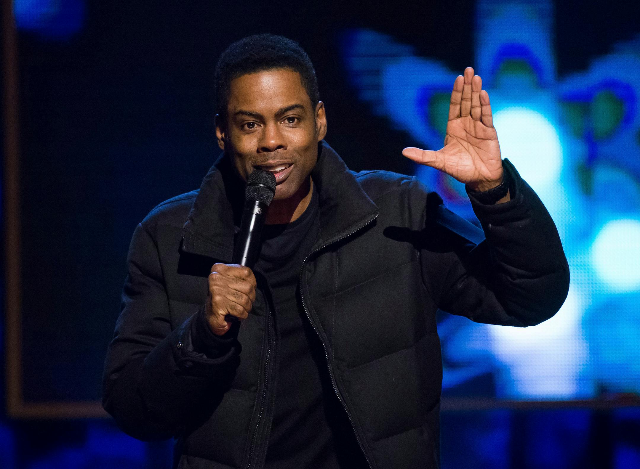 FILE - In this Feb. 28, 2015 file photo, comedian Chris Rock performs at Comedy Central's "Night of Too Many Stars: America Comes Together for Autism Programs" in New York. Netflix says the comedian is filming two stand-up specials after an eight-year absence. The first show will tape in 2017, following a new world tour. (Photo by Charles Sykes/Invision/AP, File) ORG XMIT: NYET445