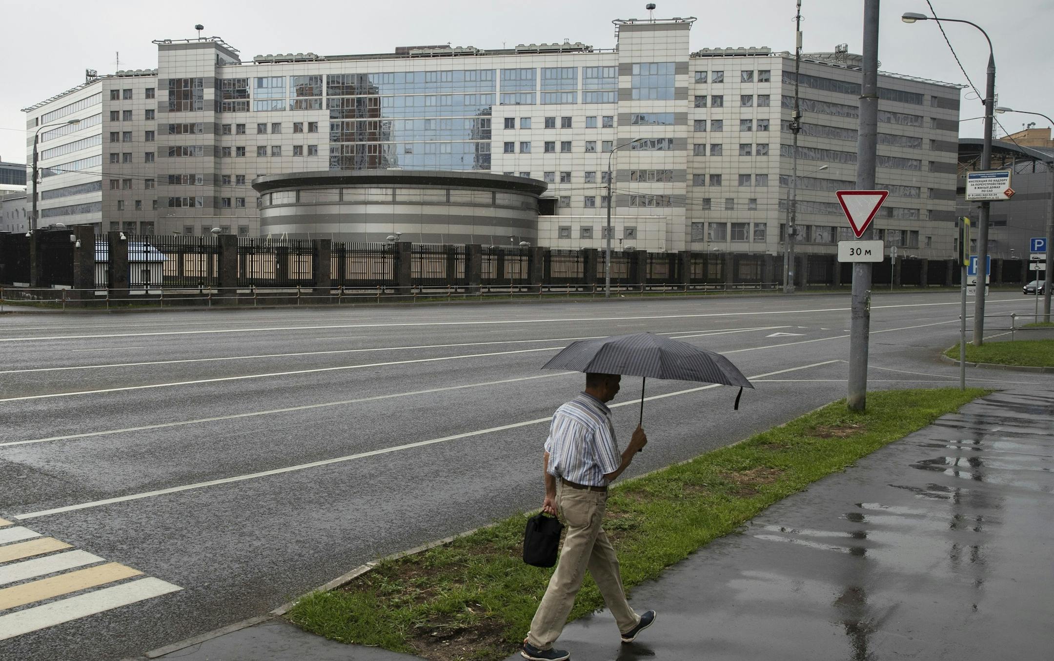 A man walks past the building of the Russian military intelligence service in Moscow, Russia, Saturday, July 14, 2018. U.S. President Donald Trump on Saturday scolded the Obama administration for not responding aggressively enough to Russian hacking of Democratic targets in the 2016 U.S. election ó cyberattacks underpinning the indictment of 12 Russian military intelligence officers. Trump's first response to special counsel Robert Mueller's initial charges against Russian government offici