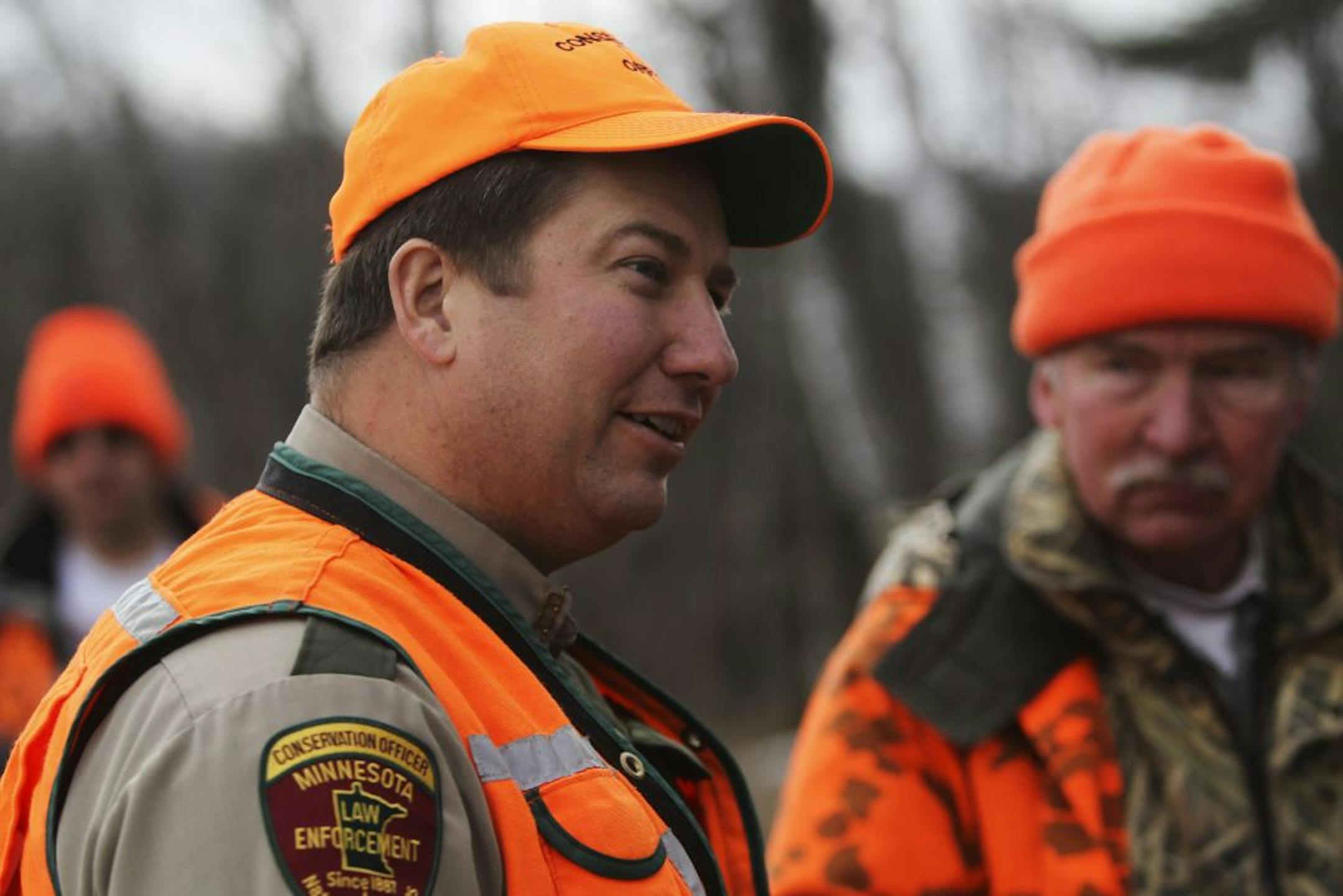 Conservation officer Dan Starr of the Tower office chatted with deer hunters after checking their licenses and firearms Saturday, Nov. 3, 2012, near Ely, MN, during the firearm deer opener as well as the state's first-ever managed wolf hunt.