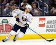 FILE - In this March 28, 2017, file photo, Buffalo Sabres forward Marcus Foligno carries the puck against the Columbus Blue Jackets during an NHL hock