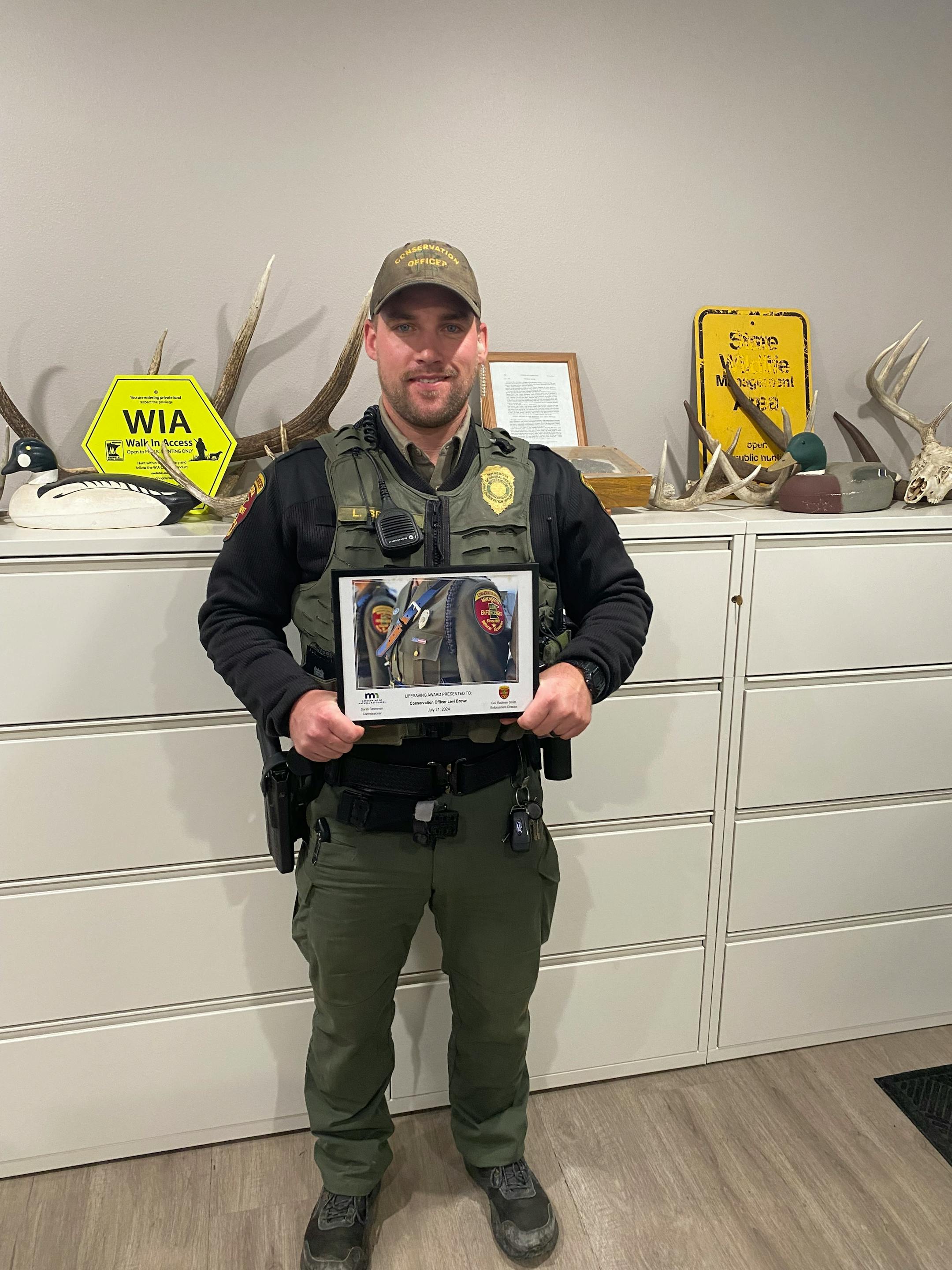 DNR conservation officer Levi Brown of Benson saved the life of a man whose head was pinned between a forklift and a tractor tire.