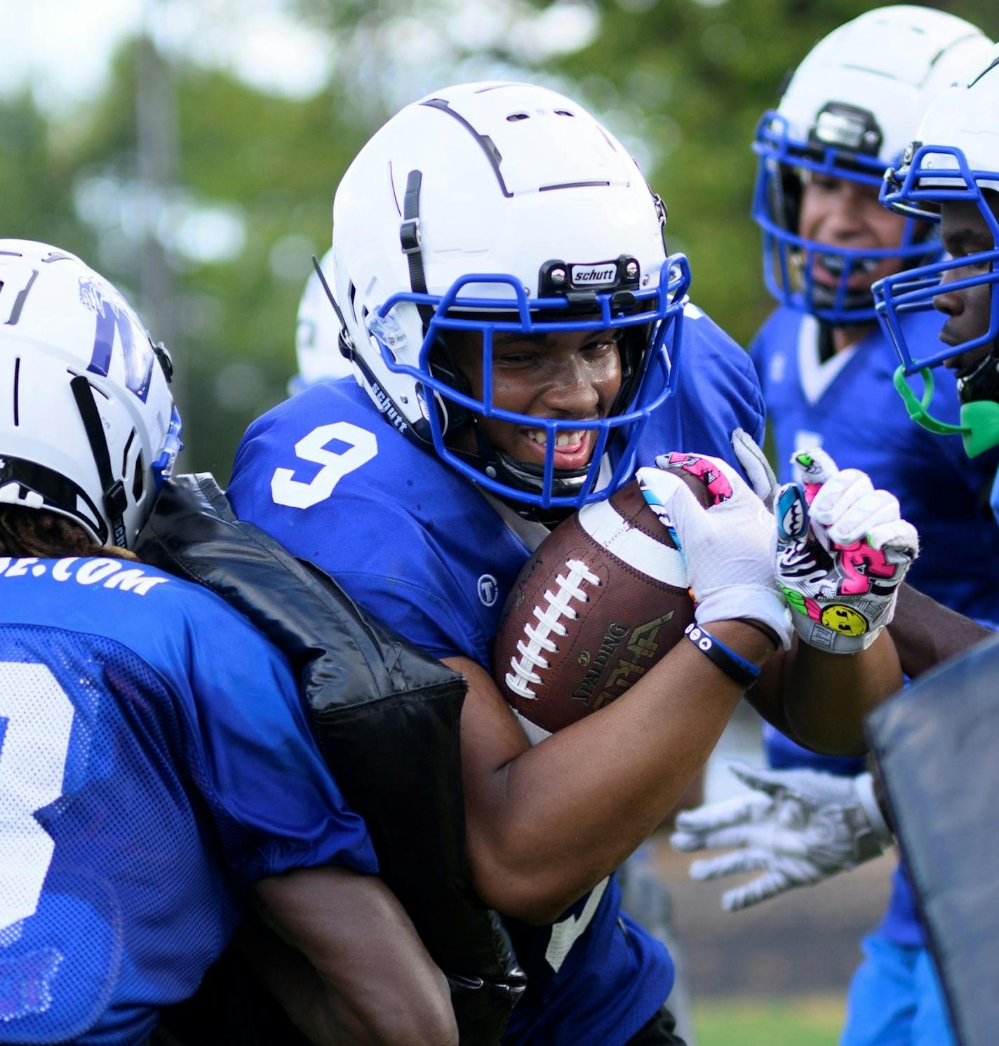 Linebacker Kahlil Brown runs through "the Gauntlet" during a Minneapolis North football practice Tuesday, Sept. 20, 2022 at the North High Athletic Field in Minneapolis, Minn.. Brown is wearing the #9, his late friend and teammate, Deshaun Hill's number, who was murdered in February in North Minneapolis. ] aaron.lavinsky@startribune.com