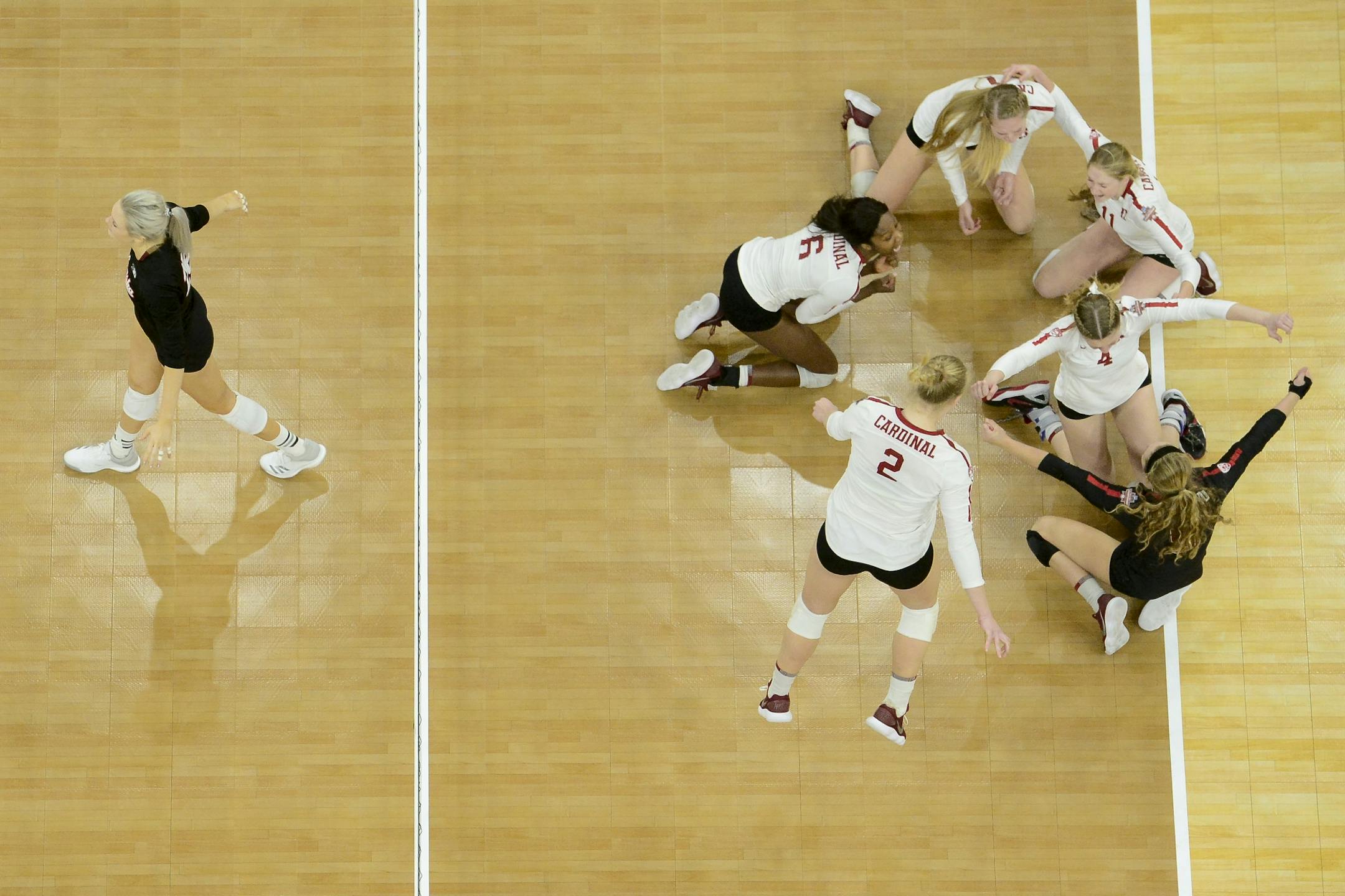 Nebraska middle blocker Lauren Stivrins (26) walked back to her team as Stanford celebrated after defeating Nebraska 3-2 in the NCAA DI volleyball championship match Saturday night.