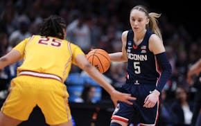 UConn guard Paige Bueckers (5) dribbles the ball as Southern California guard McKenzie Forbes (25) defends during the first half of an Elite Eight col