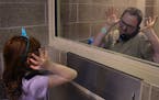 Seven-year-old Maia performs a secret handshake her and her father, Josh, 31, have created during his incarceration at Washington County jail in Still