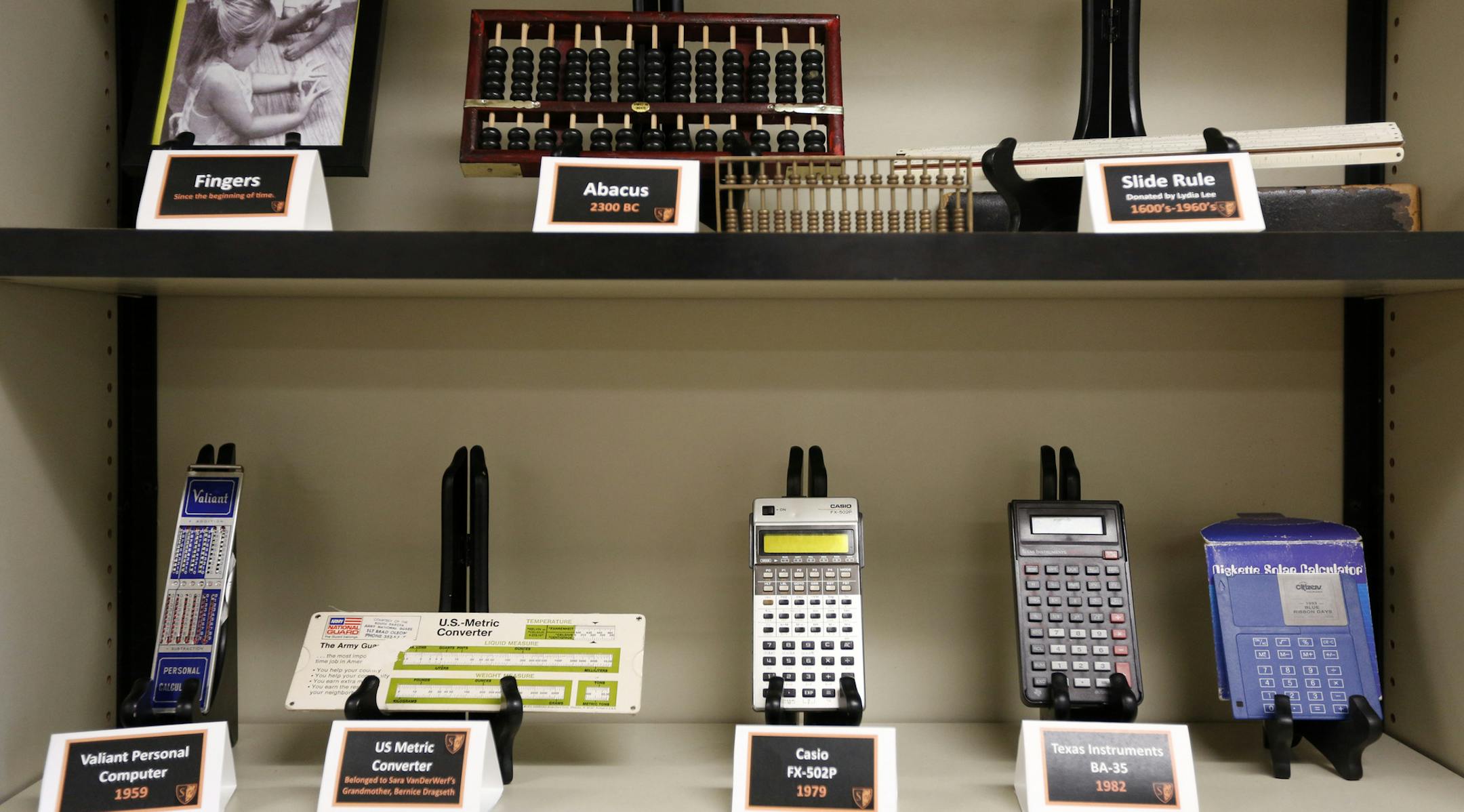 A small museum of mathematical calculators are on display in Sara Van Der Werf's Advanced Algebra class at South High. ] An app called Desmos is a free graphing calculator that can be downloaded onto a phone for use in the classroom, and at home. At places like South High, it's a story of equity and access. Not all kids in the district can afford to shell out more than $100 for a graphing calculator, but most have phones or have a family member with one. Educators say it helps bridge the gap and