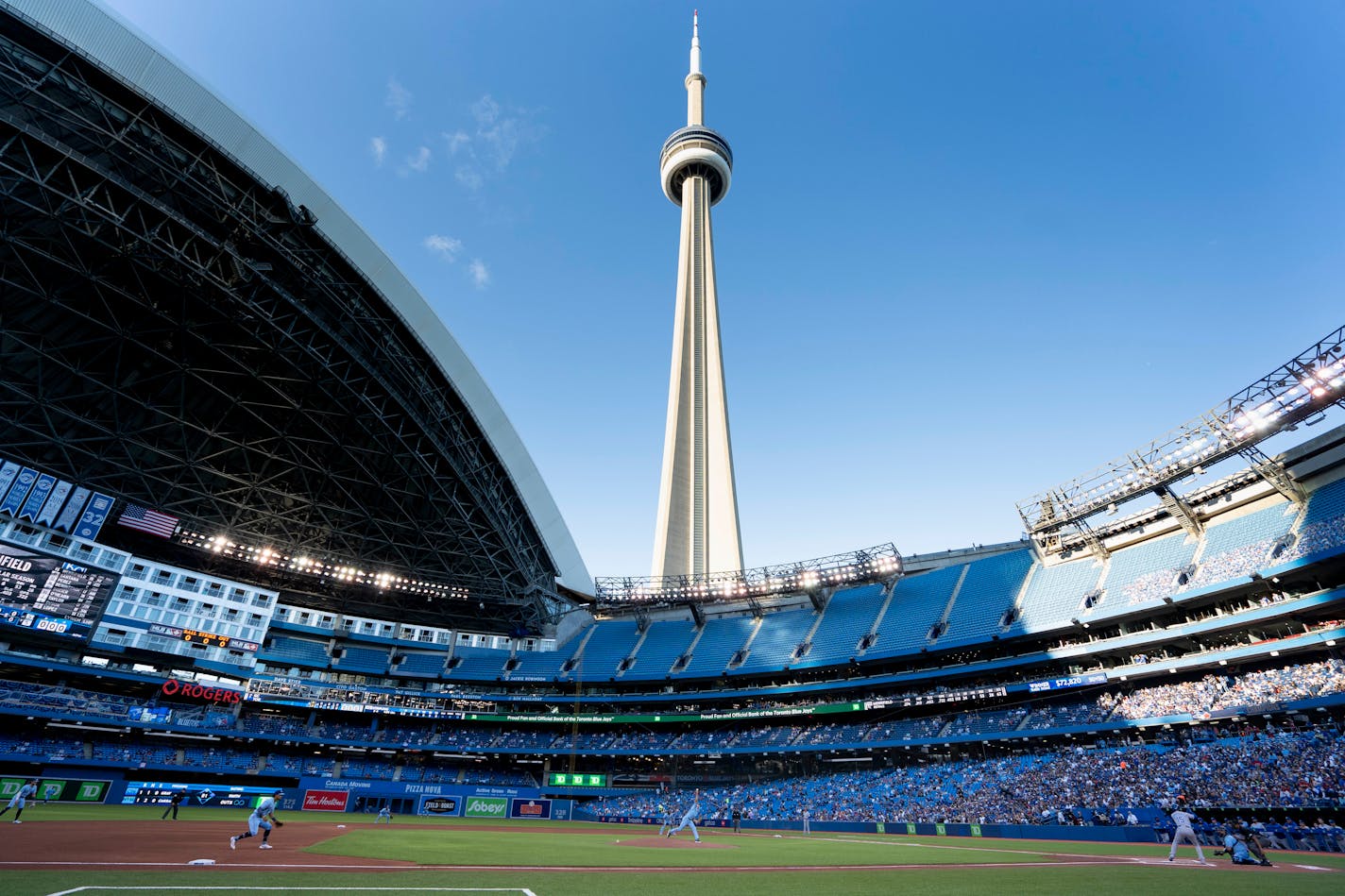 Toronto Blue Jays starting pitcher Ross Stripling throws the opening pitch of the team's baseball game against the Kansas City Royals on Friday, July 30, 2021, in Toronto. The Blue Jays were playing in Toronto for the first time since the COVID-19 pandemic began. (Peter Power/The Canadian Press via AP)