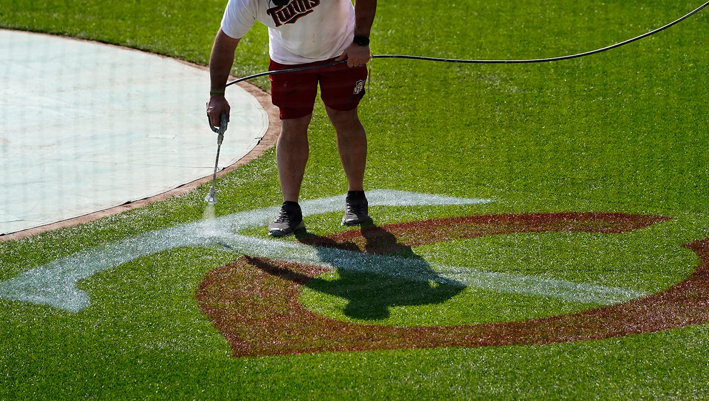 Grounds crew members prepare Target Field for Thursday's home opener