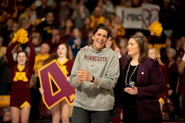 Janel McCarville stood with Gopher's coach and former teammate Lindsay Whalen during her jersey retirement before the game.