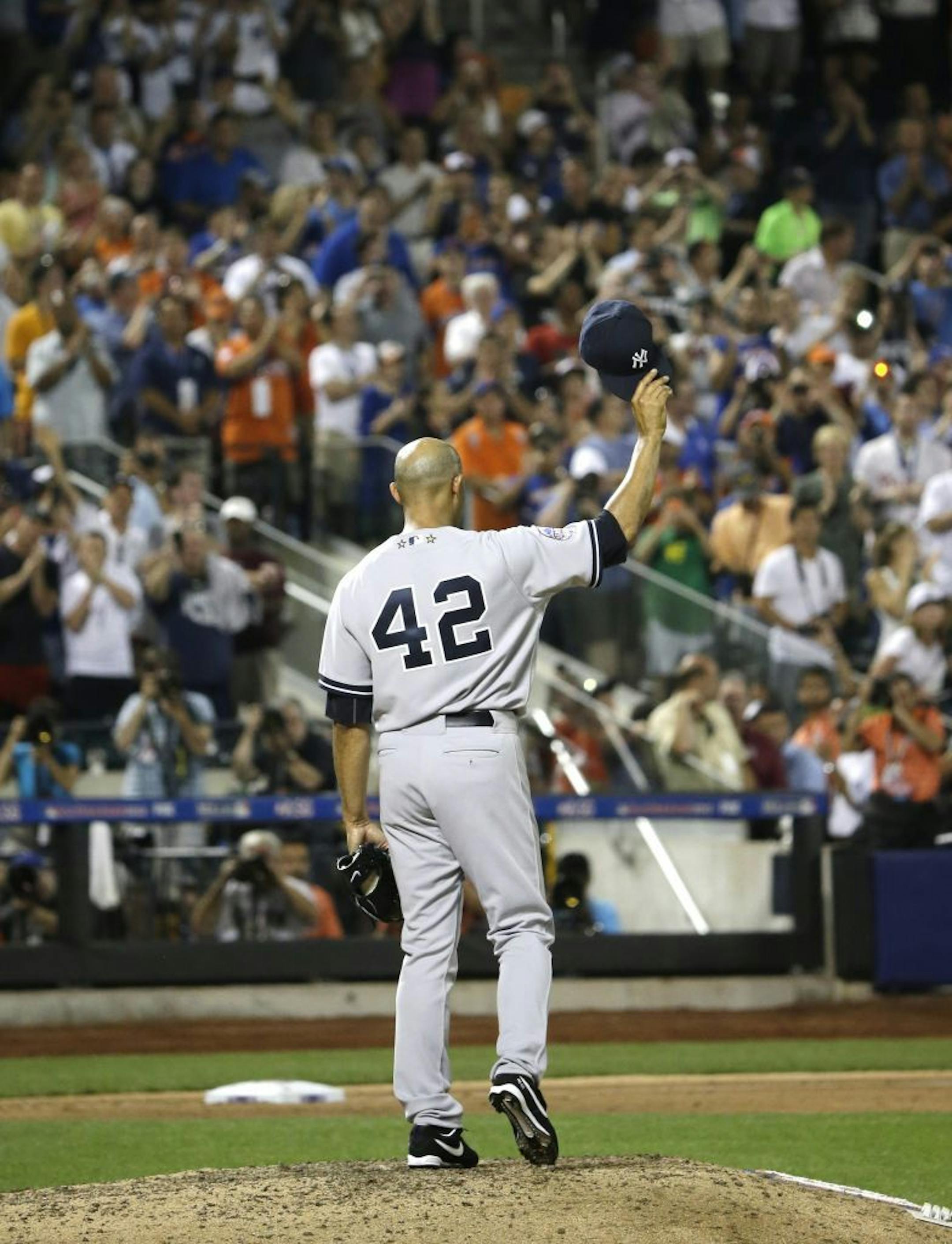 Mariano Rivera, of the New York Yankees, acknowledges a standing ovation during the eighth inning of the MLB All-Star game, on Tuesday, July 16, 2013, in New York.