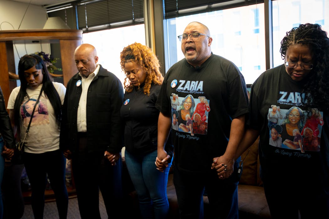 Paul Greer, stepfather of Zaria McKeever who was murdered in a home invasion in November 2022, leads the prayer with other family members at a small vigil at Shiloh Temple on Friday in Minneapolis.