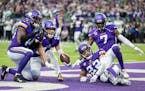 Camryn Bynum (24) of the Minnesota Vikings celebrates with teammates after intercepting a pass in the fourth quarter.