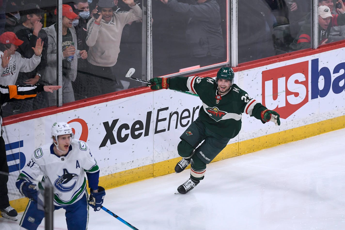 Minnesota Wild left wing Kevin Fiala, right, celebrates his goal as Vancouver Canucks defenseman Tyler Myers skates away during the second period of an NHL hockey game Thursday, April 21, 2022, in St. Paul, Minn. (AP Photo/Craig Lassig)