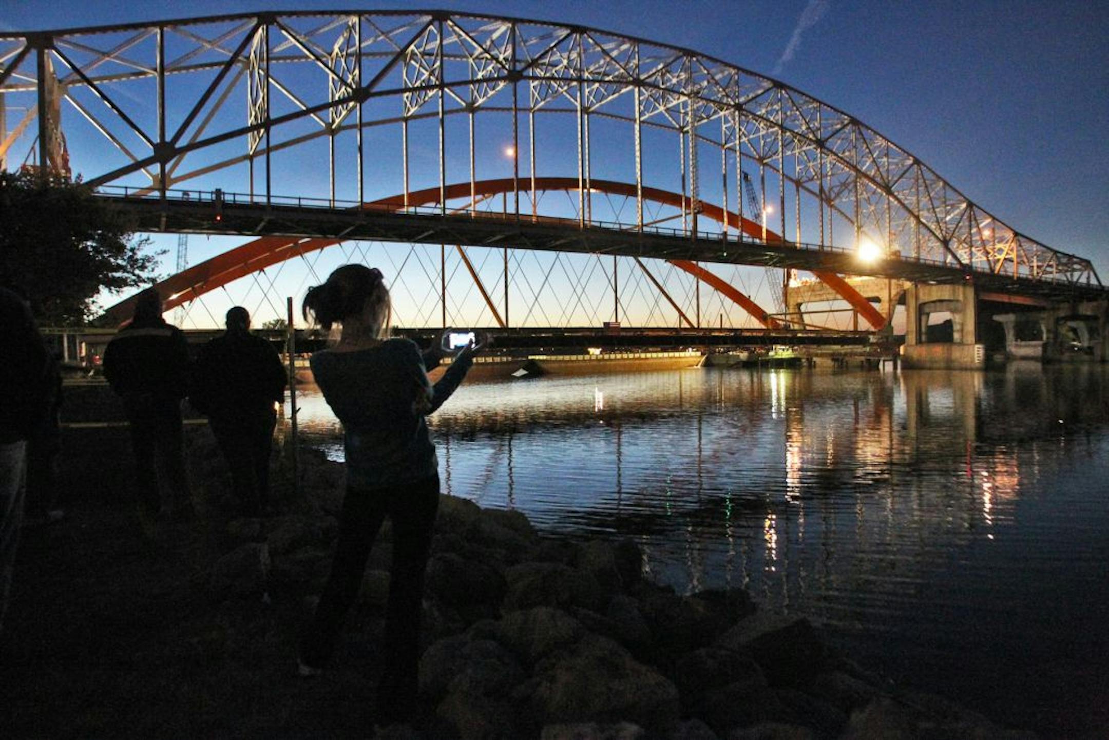 Pedestrians watched as the massive new span of the Hwy. 61 bridge crossing the Mississippi River in Hastings was raised into position this week.