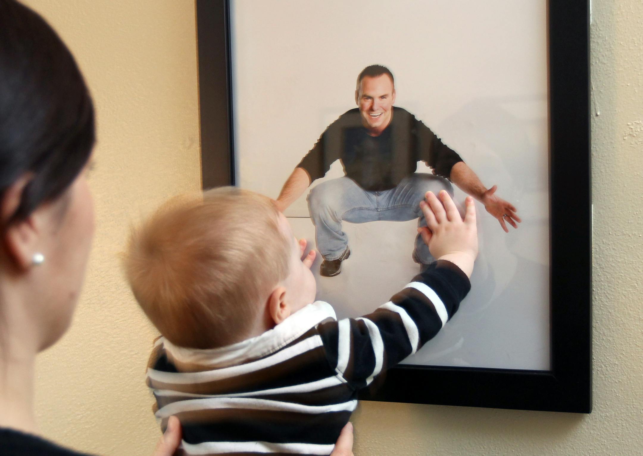 Shane Myre's photo above the changing table helps his mother, Gloria, keep him in baby Gabe's presence until he returns from Kuwait after a 10-month deployment.