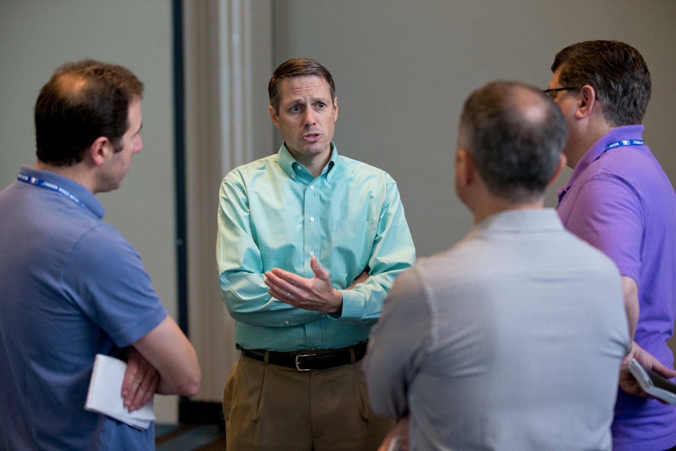 John Ricco, second from left, New York Mets assistant general manager, speaks to reporters after attending the baseball general managers' meetings, Wednesday, Nov. 11, 2015, in Boca Raton, Fla. (AP Photo/Wilfredo Lee)