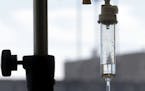 FILE - In this Sept. 5, 2013 file photo, chemotherapy is administered to a cancer patient via intravenous drip in Durham, N.C. In a study sponsored by
