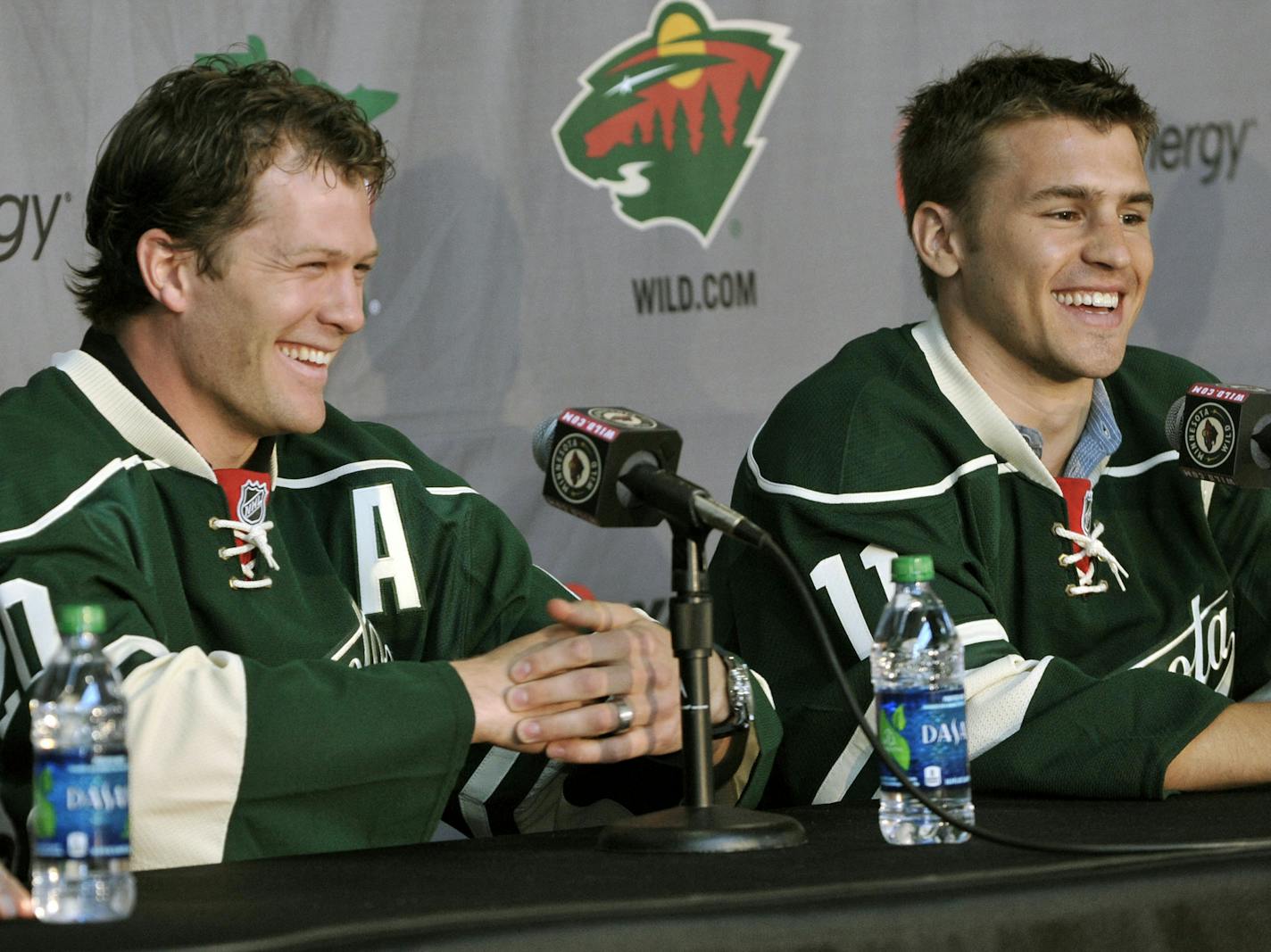 New Minnesota Wild NHL hockey players Ryan Suter, left, and Zach Parise are introduced during a news conference Monday, July 9, 2012 in St. Paul, Minn. The two signed 13-year contracts with the Wild for $98 million. (AP Photo/Jim Mone)