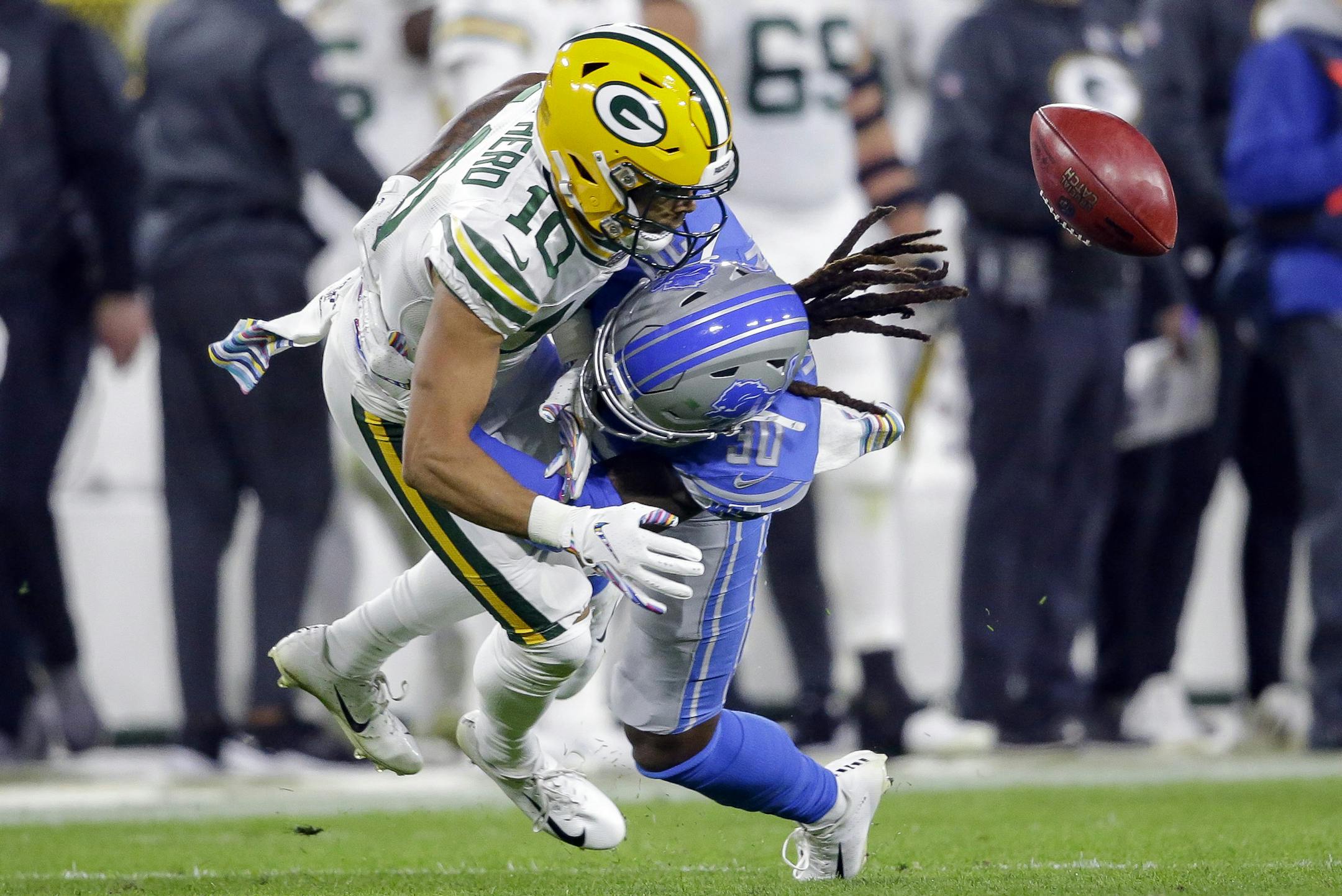 Green Bay Packers wide receiver Darrius Shepherd (10) fumbles a punt after getting hit by Detroit Lions defensive back Dee Virgin during the second half of an NFL football game Monday, Oct. 14, 2019, in Green Bay, Wis. (AP Photo/Jeffrey Phelps)