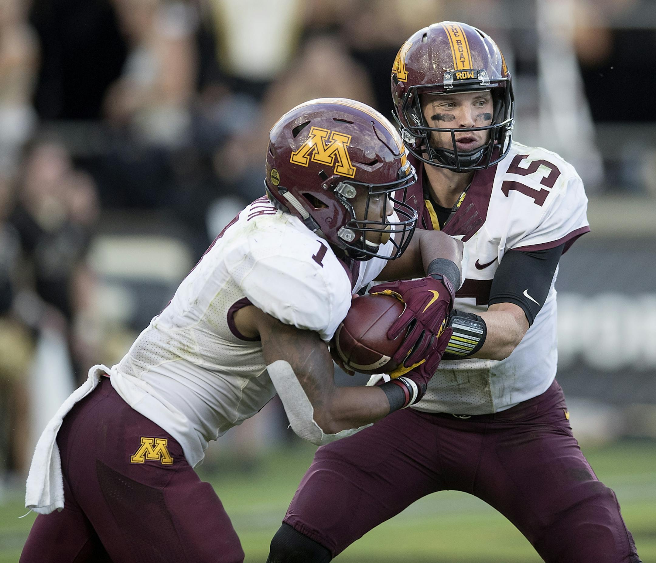 Minnesota's quarterback Conor Rhoda handed the ball to running back Rodney Smith during the third quarter the Gophers took on Purdue at Ross-Ade Stadium, Saturday, October 7, 2017 in West Lafayette, IN.