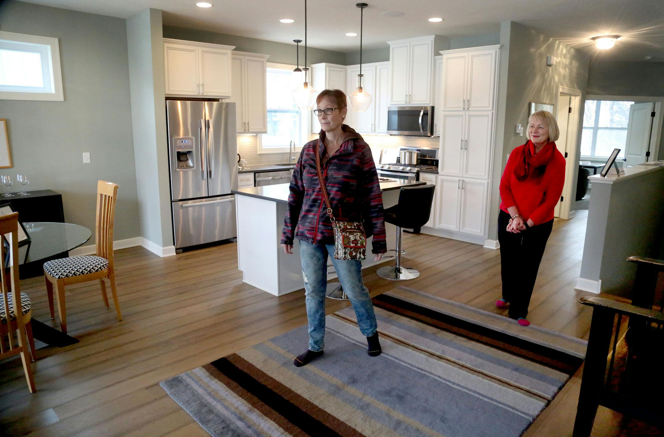 Jason Stockwell and Diane Eldredge, sales agents with Remax Result, hosted an open house at this new 4 bedroom, 3 bath 3,300 square foot rambler in Roseville, one of 18 similar units built by a non-profit developer. Here, Eldredge, right, and Stockwell, not pictured, showed off the unit to Sue Carlson of Shoreview Saturday, Dec. 10, 2016, in Roseville, MN.] (DAVID JOLES STARTRIBUNE)djoles@startribune.com Did a spike in mortgate rates deter home buyers in the Twin Cities metro? Or push them off t