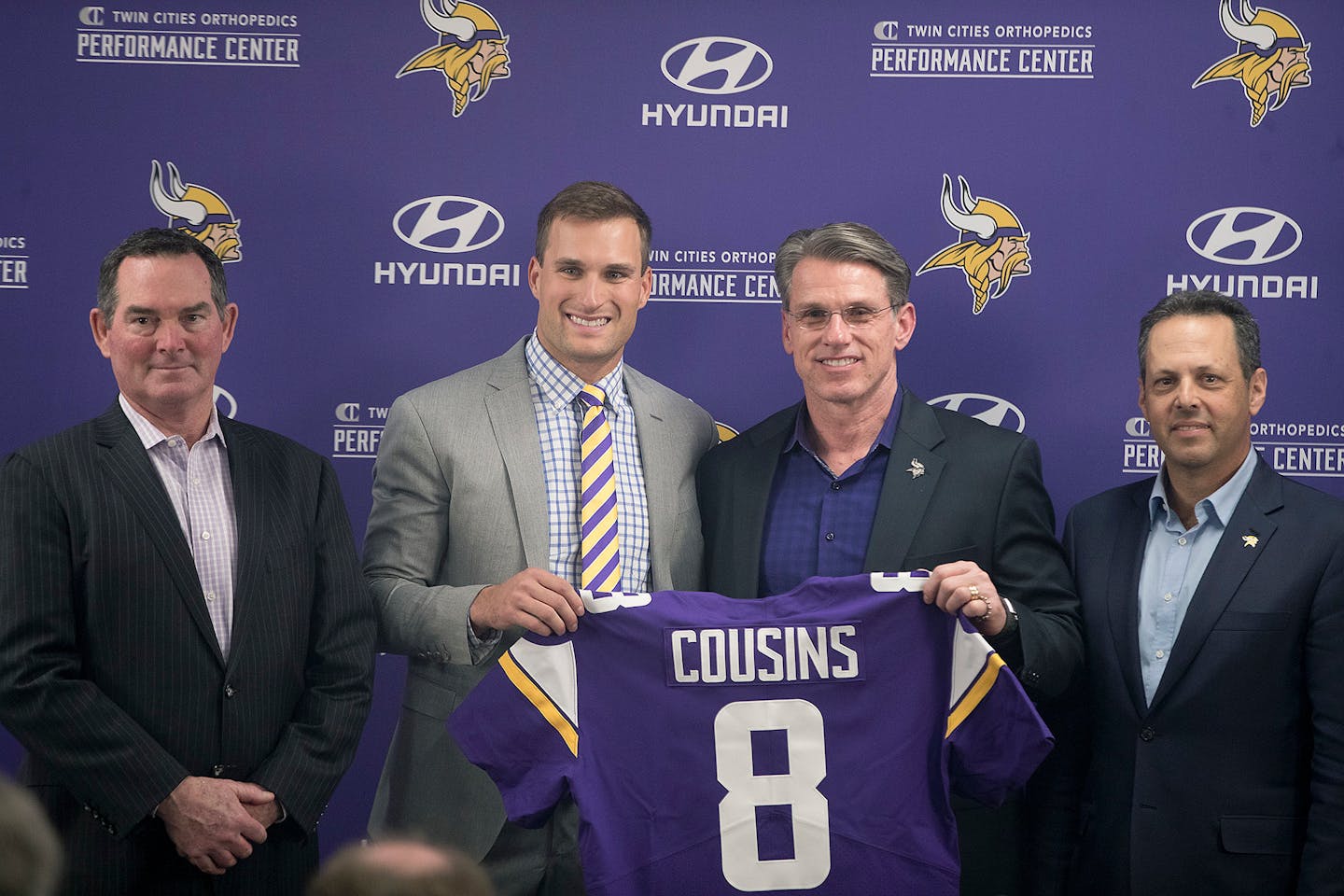 Vikings coach Mike Zimmer, left, stood next to Kirk Cousins, along with GM Rick Spielman and co-owner Mark Wilf on Thursday.