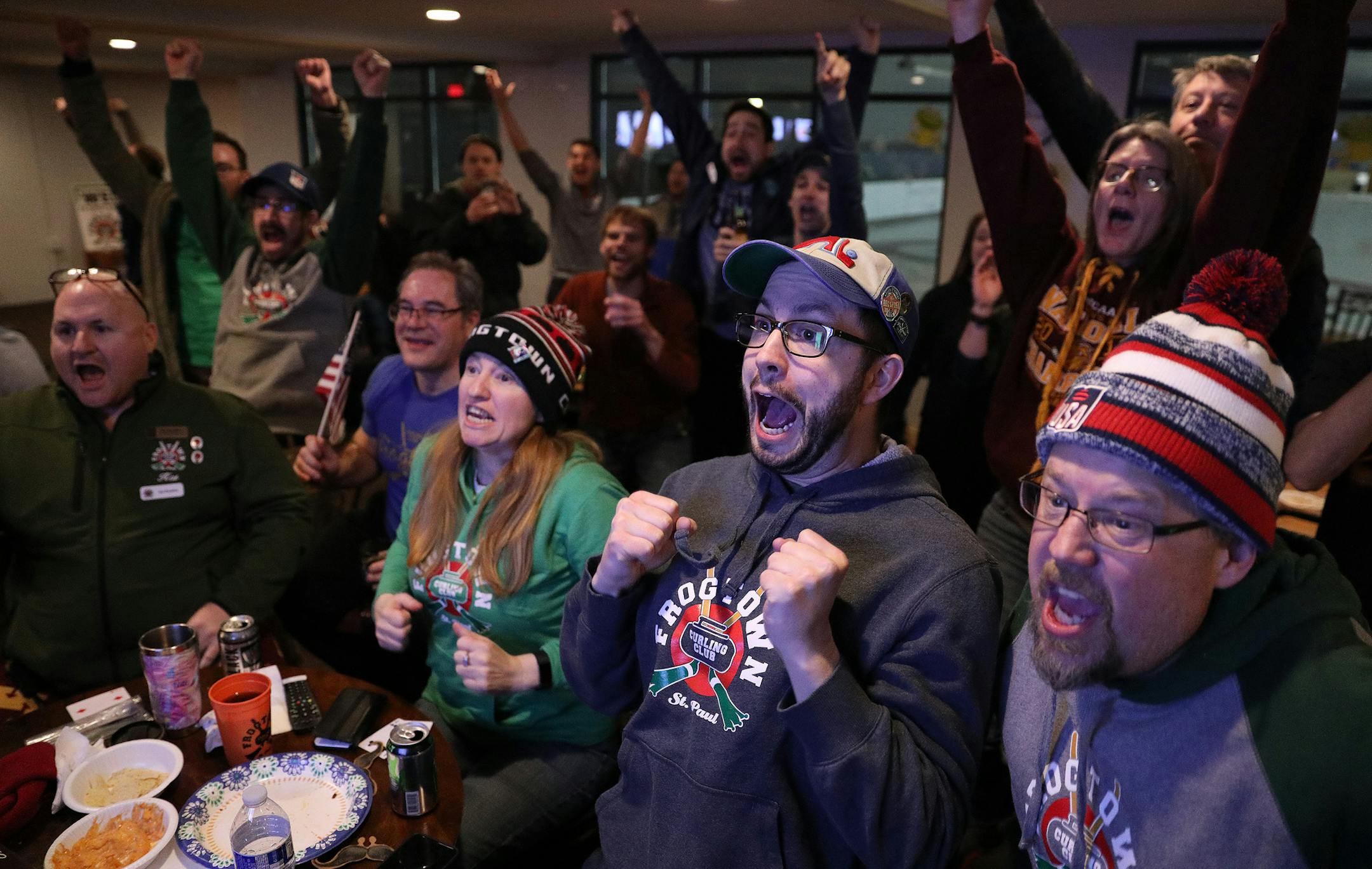 Curling fans, from left, Kat Beaulieu, Rob Engberg (with flag), Fiona Ruthven, Craig Downs, and Joel Ingersoll reacted with others as the United States scored five in the eighth against Sweden for the Olympic gold medal during a watch party at the Frogtown Curling Club. ] ANTHONY SOUFFLE ï anthony.souffle@startribune.com Curling fans gathered to watch the United States compete against Sweden for the gold medal in the Olympics Saturday, Feb. 24, 2018 at the Frogtown Curling Club in St. Paul,