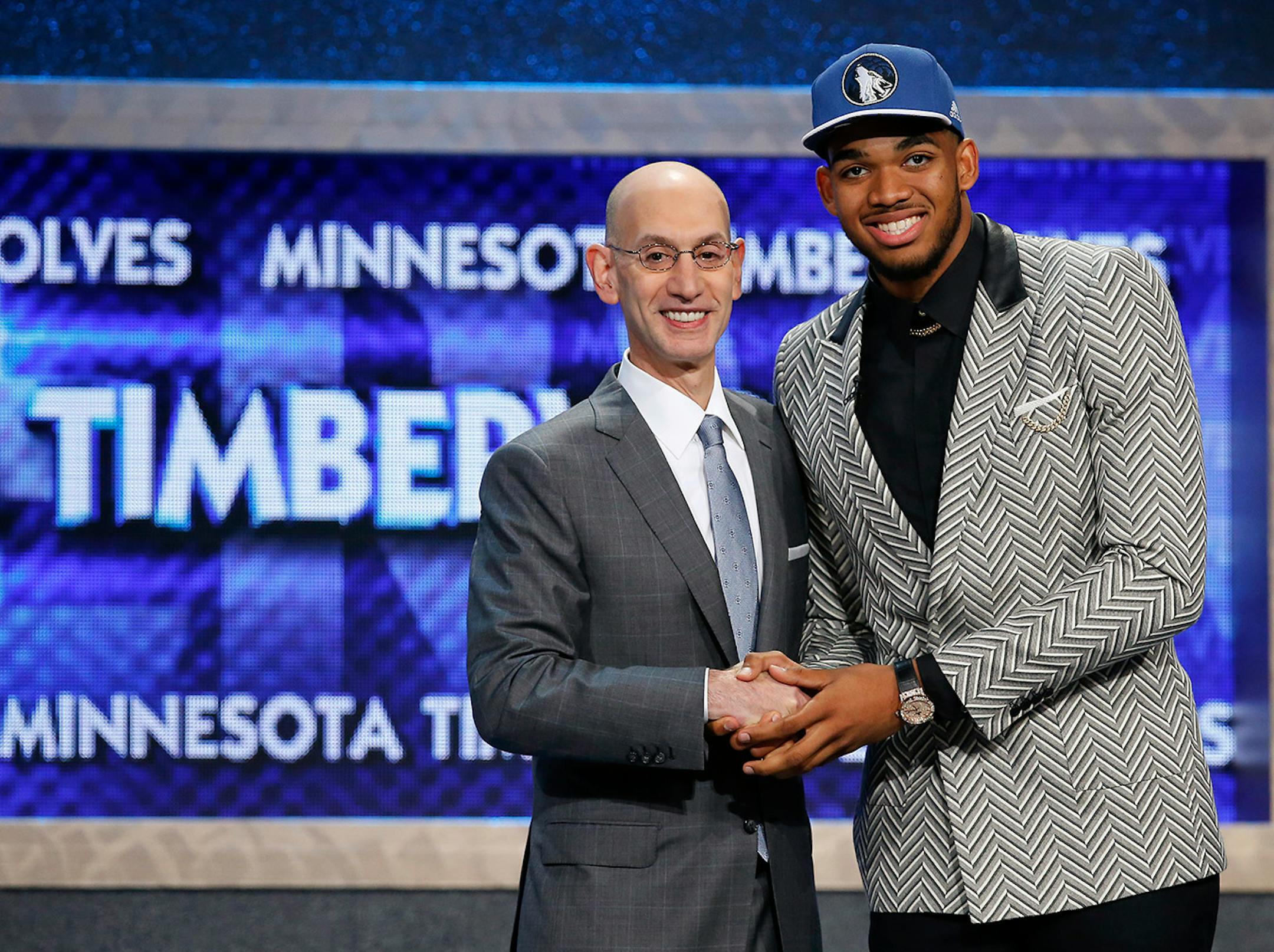 Karl-Anthony Towns, right, poses for a photo with NBA Commissioner Adam Silver after being announced as the top pick during the NBA basketball draft by the Minnesota Timberwolves, Thursday, June 25, 2015, in New York. (AP Photo/Kathy Willens)