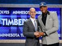 Karl-Anthony Towns, right, poses for a photo with NBA Commissioner Adam Silver after being announced as the top pick during the NBA basketball draft b