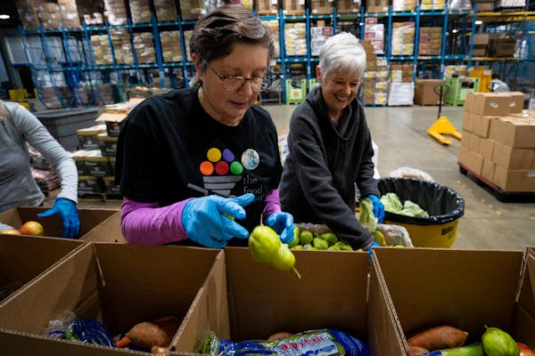 Laura Wennik, a volunteer with the Food Group, packed pears into produce boxes last week during the food bank’s “Pack to the Max” event on Give 