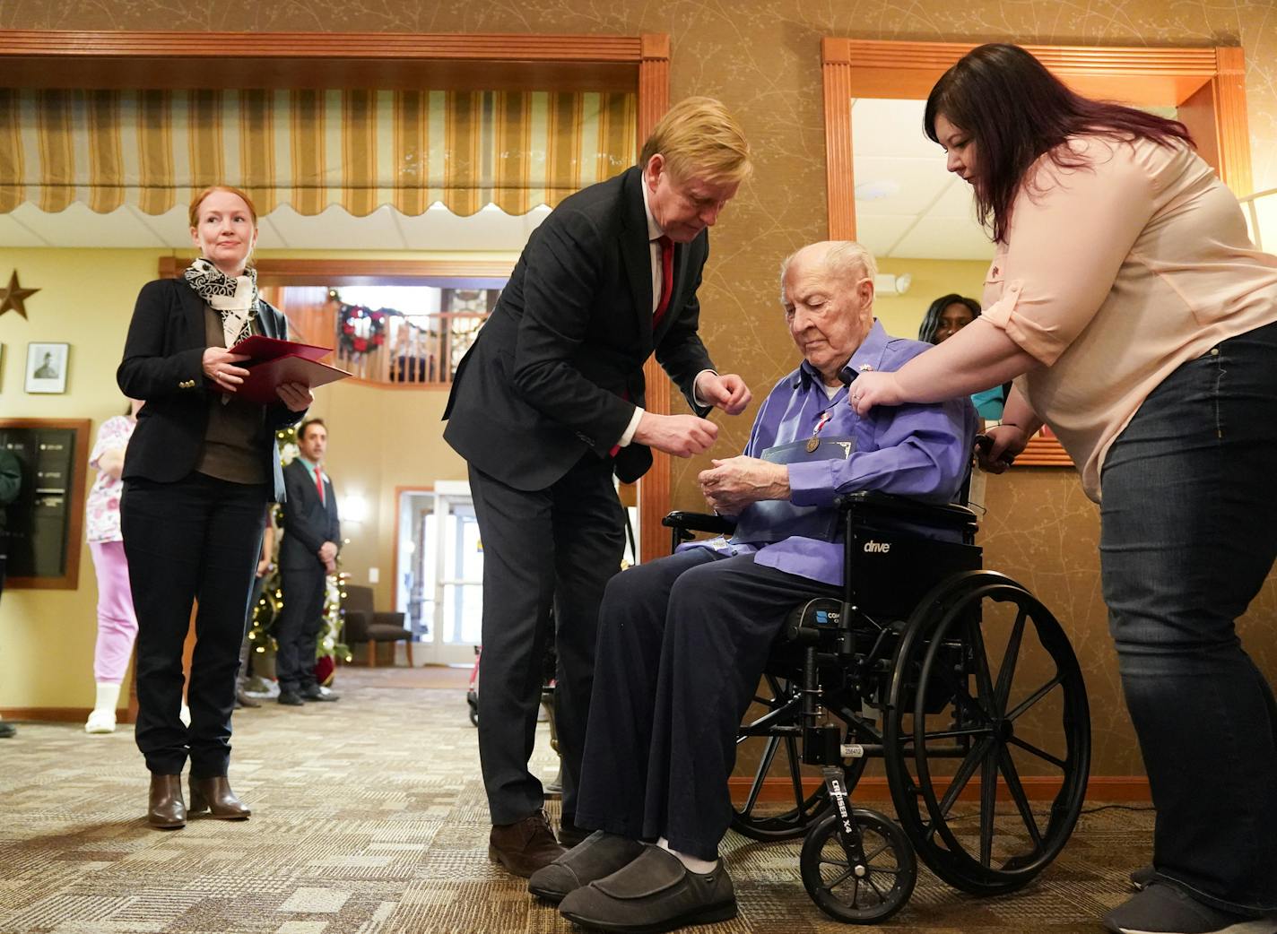 Norwegian Ambassador K&#xe5;re R. Aas presented two medals to 100-year-old Wilton Rasmusson, who served under the Office of Strategic Services' Norwegian Operational Unit, NORSO II, during World War II. On the right is Wilton's grand daughter Amber. ] GLEN STUBBE &#x2022; glen.stubbe@startribune.com Sunday, December 8, 2019 Norwegian Ambassador K&#xe5;re R. Aas presented two medals to 100-year-old Wilton Rasmusson, who served under the Office of Strategic Services' Norwegian Operational Unit, NO