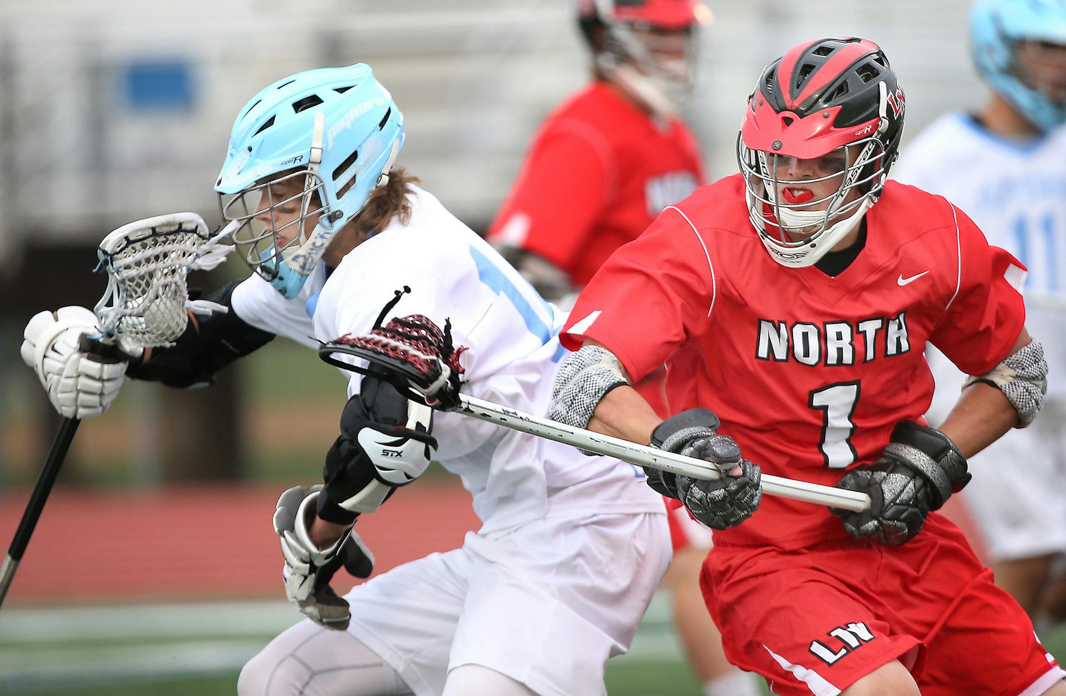 Bloomington's Ryan Graff kept possession of the ball despite defensive pressure by Lakeville North's Dakota Toedter in the first quarter during the boys' lacrosse state semifinals at Hopkins High School, Thursday, June 11, 2015 in Hopkins, MN. ] (ELIZABETH FLORES/STAR TRIBUNE) ELIZABETH FLORES • eflores@startribune.com