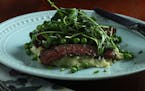 Ginger-seared skirt steak is served on a bed of grits and is topped with peas, baby lettuce and pea shoots. (Abel Uribe/Chicago Tribune/TNS) ORG XMIT: